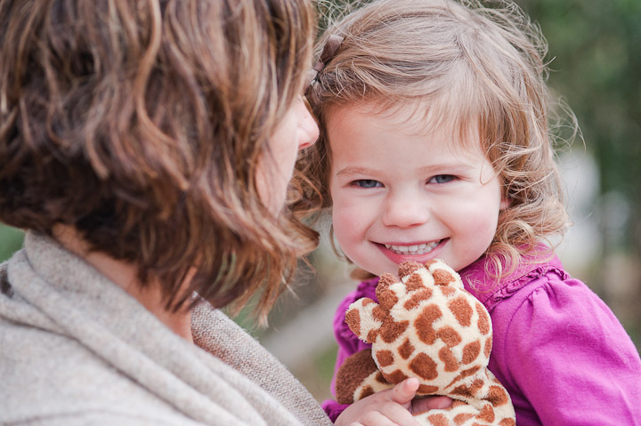 Beautiful Girl smiling with mom and stuffed animal