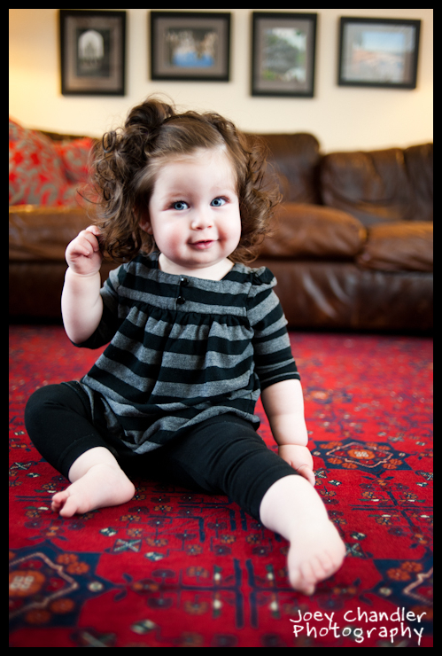 Beautiful Zoe playing wih her hair - San Francisco Baby Photographer Baby girl playing with hair in front of a couch - San Francisco Baby Photographer