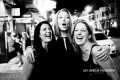 Three women laughing and hugging in San Francisco's North Beach District