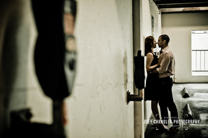 Couple kissing along a wall in a parking garage along chestnut street in San Francisco