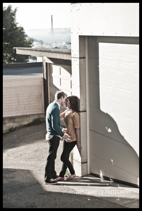 A San Francisco Moment Photograph of an Engaged Couple kissing in San Francisco with the Golden Gate Bridge