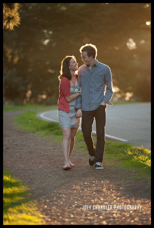 Love their smiles Engaged couple walking arm and arm in the Presidio in San Francisco