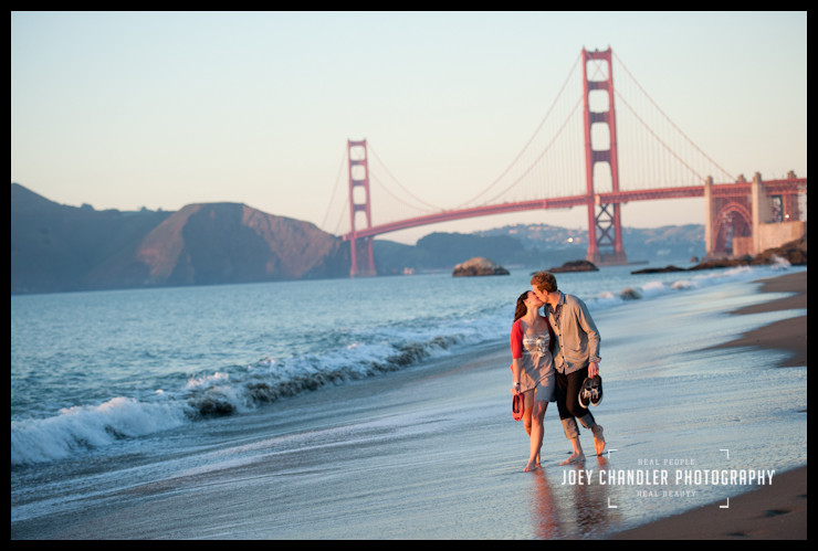 Another perfect San Francisco Moment Engaged Couple walking in the surf at Baker Beach with the Golden Gate Bridge