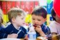 Two boys Sharing cupcakes at a party at Acrosports in San Francisco
