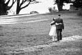Happy couple walking arm-in-arm at Sutro Heights Park - San Francisco Wedding Photographer Joey Chandler