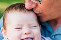 Father Kissing baby girl at Sutro heights park - San Francisco Family Photographer Joey Chandler