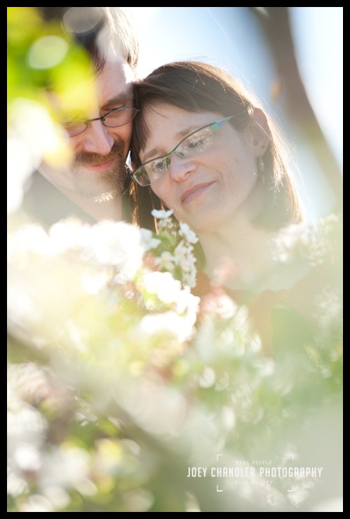 A moment among the cherry trees at the legion of honor A couple hugging in cherry tree blossoms -San Francisco Engagement Photography