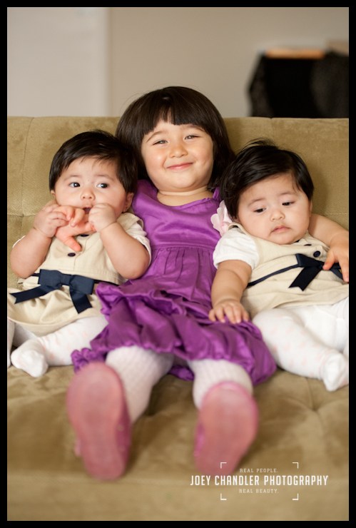 Proud big sister Girl hugging her twin baby sisters - San Francisco Child Photography
