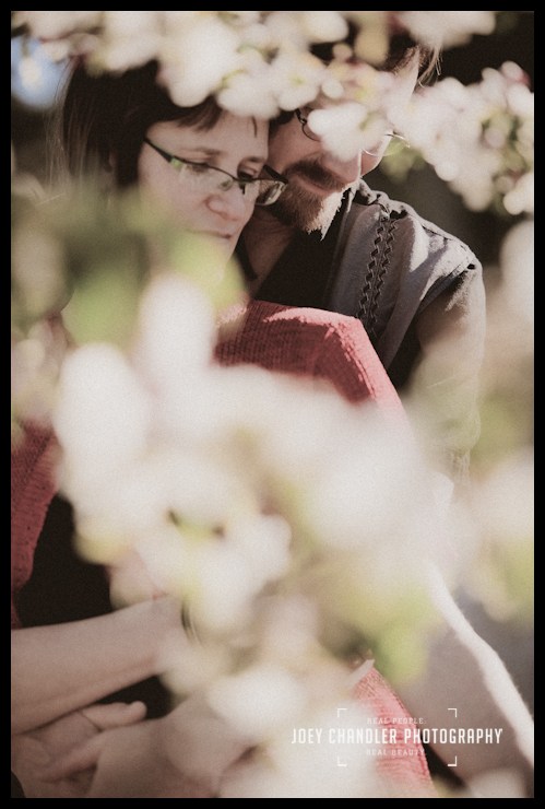 Spring love in the Cherry Trees Couple embracing behind a cherry tree blossom-San Francisco Engagement Photography
