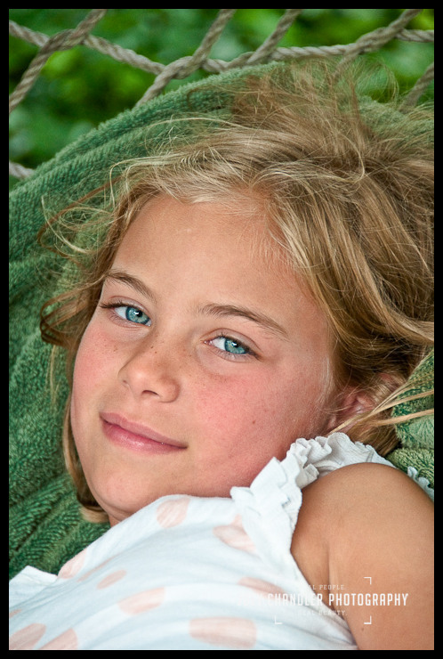 Girl smiling for a family photograph on a hammock in Seagirt Girl smiling for a family photograph on a hammock in Seagirt