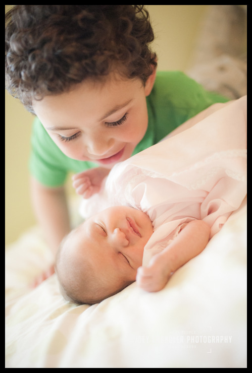 Big brother protecting baby sister Older brother kissing newborn baby sister at San Francisco Naming Ceremony-11