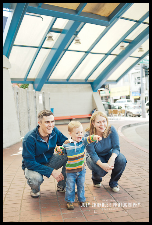 TRAIN and smiles at the Muni Station for family portraits Family looking at trains at Muni Station in San Francisco