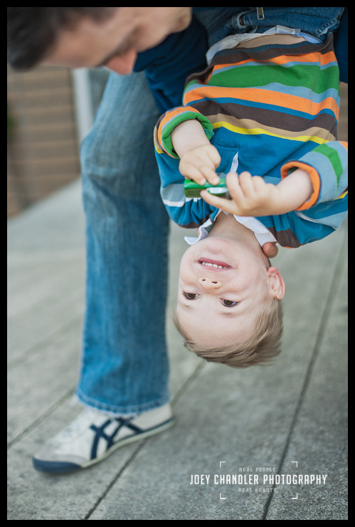Upside down smiles for family photographs in San Francisco Dad holding son upside down during family photographs in San Francisco