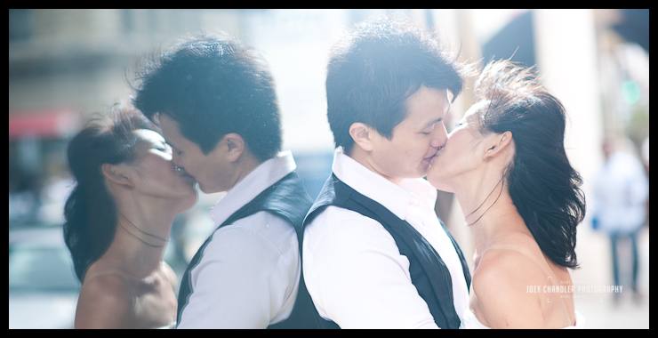A San Francisco kiss Engaged Couple kissing in from of a mirror storefront in San Francisco