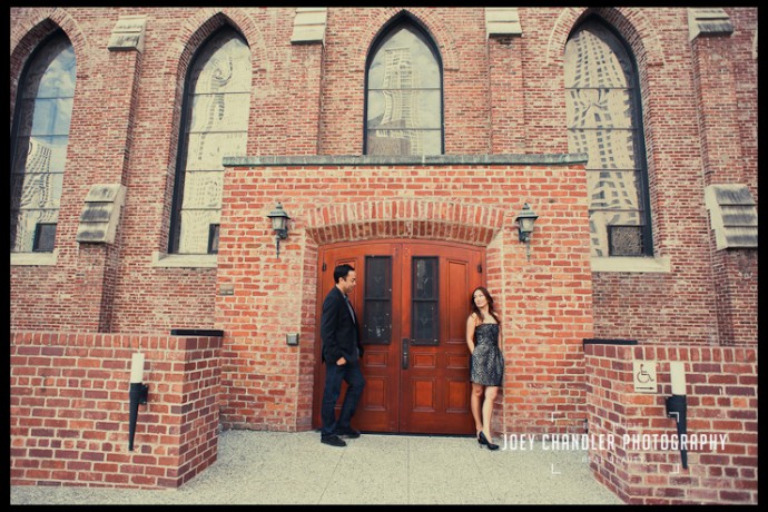 In the imosing entrance of the brick facade of San Francisco's Jewish Museum, a well-dressed couple flirts.