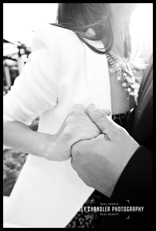 Romance on a San Francisco Date Black and white close-up image of a husband and wife holding hands. She is wearing jewelry and a white jacket.