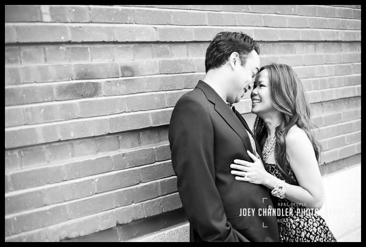 Mom and dad hugging in San Francisco Couple smiling playfully as their bodies press agians each other.