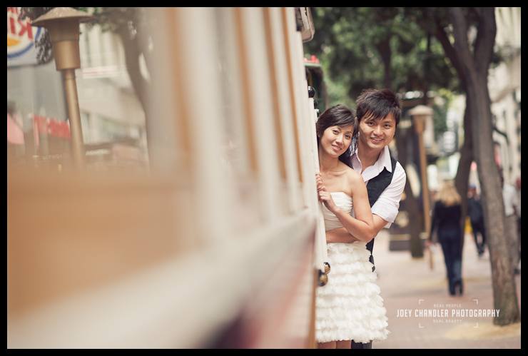 Smiles on a San Francisco Cable Car Engaged couple hanging off a San Francisco Cable Car