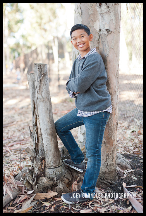 Boy posing for a picture in the woods at Perry Farms