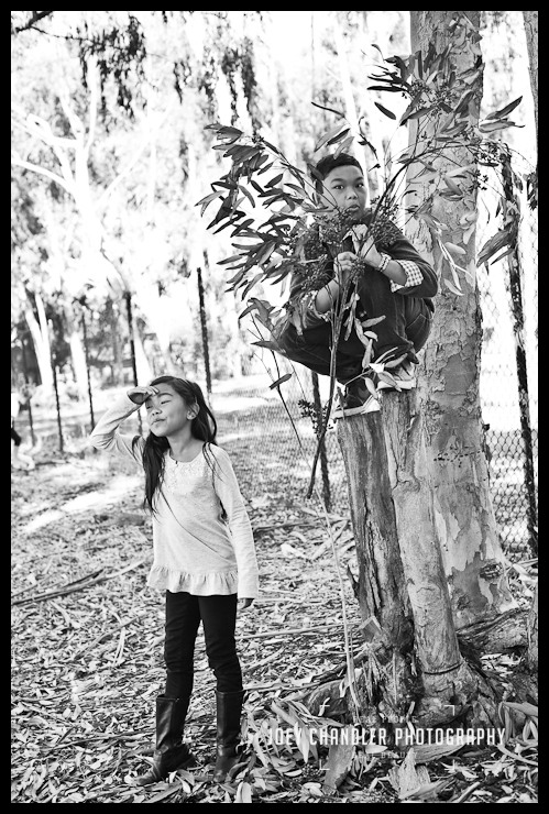 Brother and sister playing in the woods at Perry Farms
