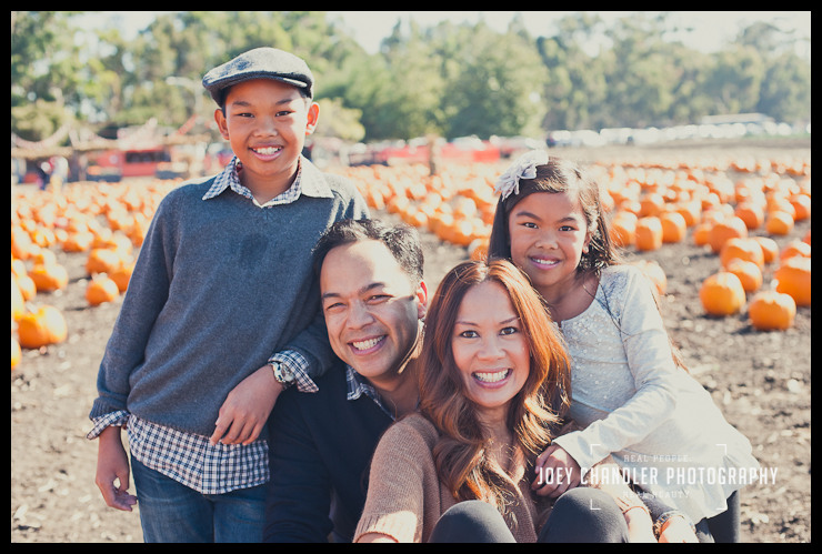 Family of four smiling at Perry's Pumpkin Patch