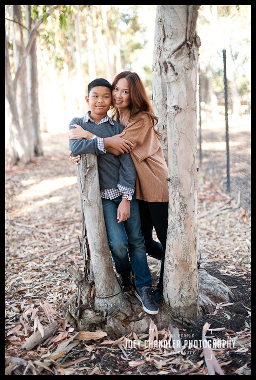 Mom hugging son in the woods at Perry Farms