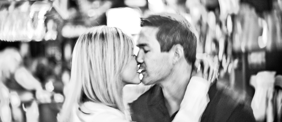 Engaged couple kissing in San Francisco Bar